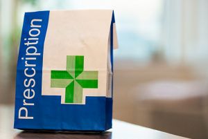 A close-up image of a paper bag containing prescribed medical items.